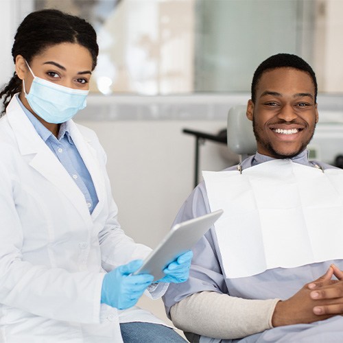 patient smiling while visiting dentist 